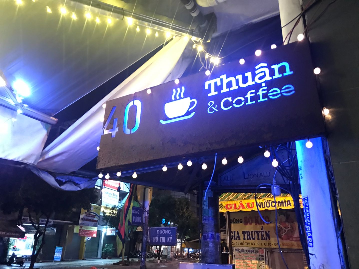 The glowing 40 Thuan & Coffee storefront sign at night