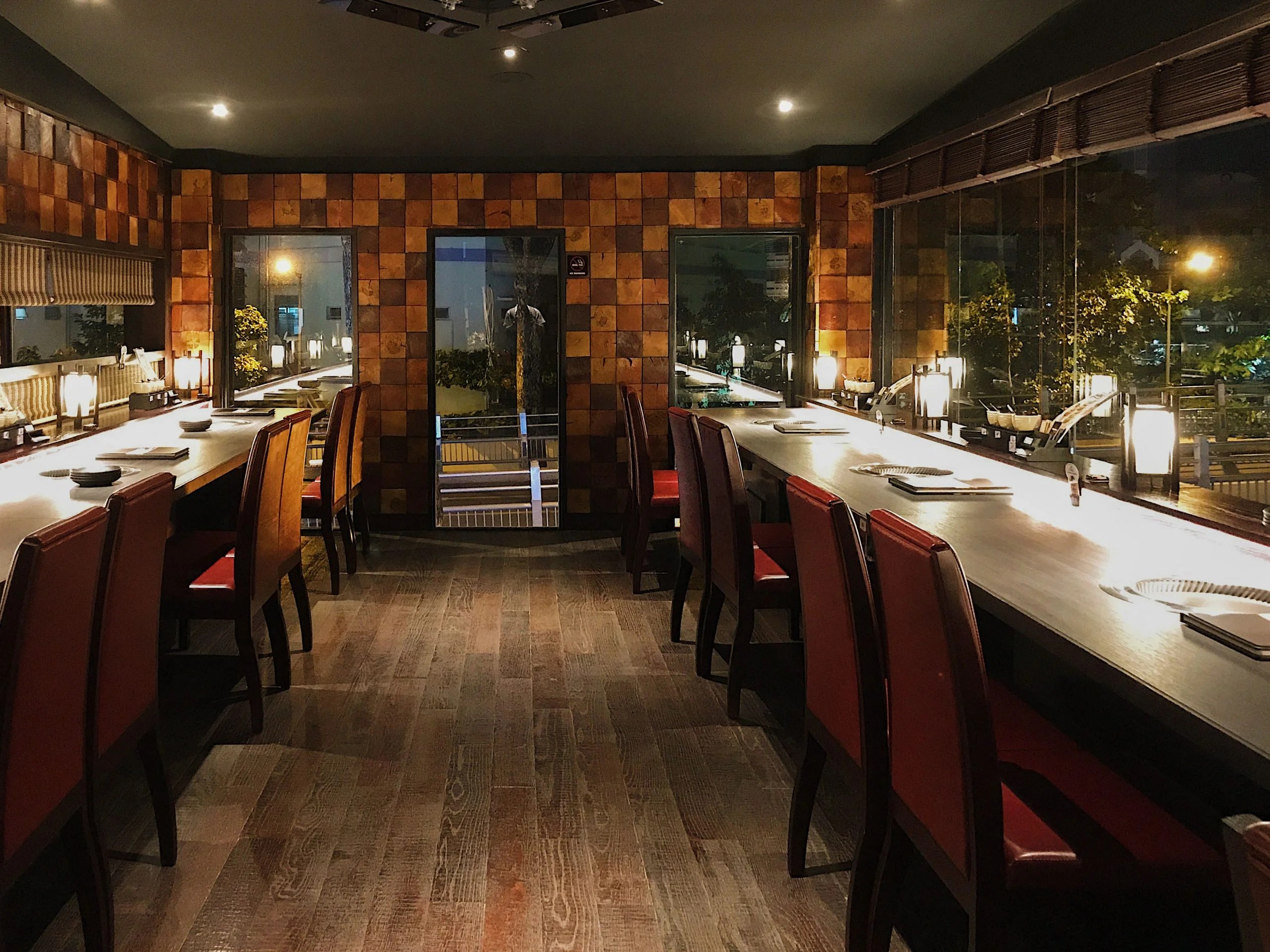 The dining hall: wood-tile walls, lantern glow, grills on every counter