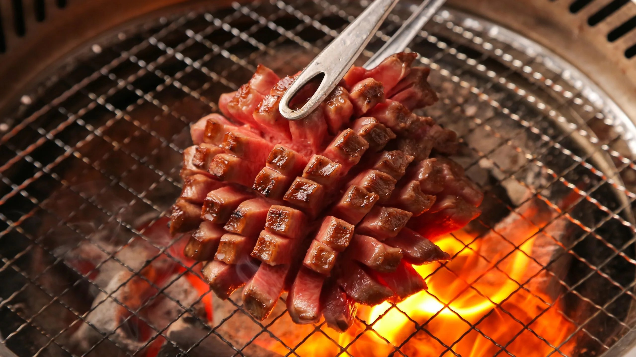 Beef grilling over the yakiniku charcoal fire