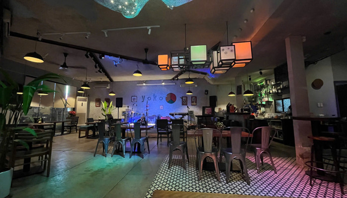 Yoko — the wide interior: the stage, yoko sign, lanterns, patterned tile floor